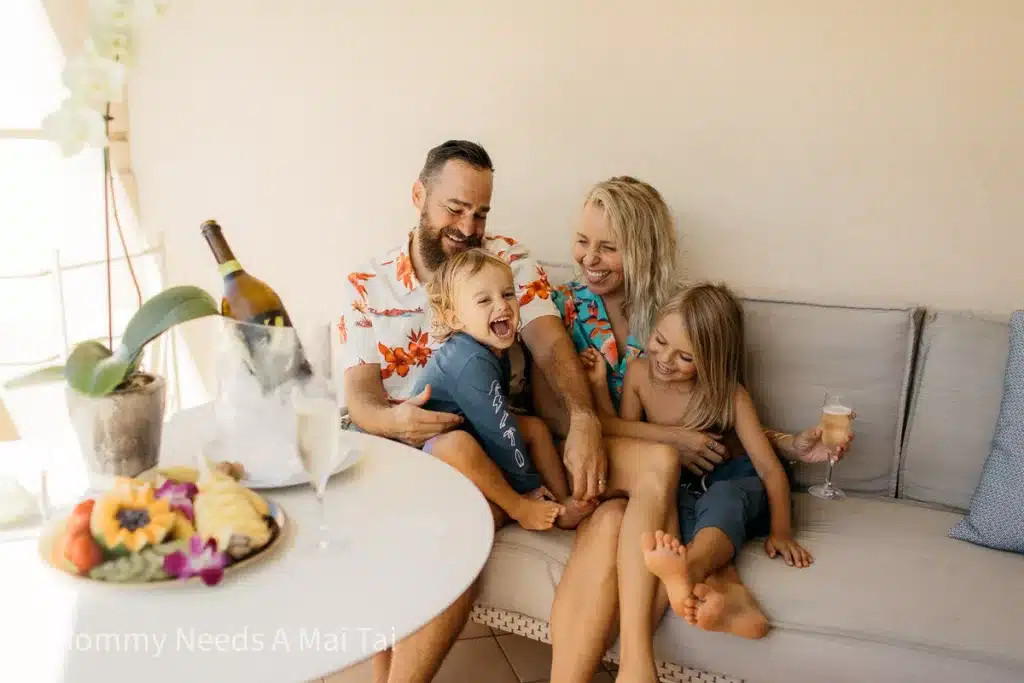 Gia đình vui vẻ uống champagne và chơi đùa trên hiên nhà tại Four Seasons Resort ở Maui, Hawaii